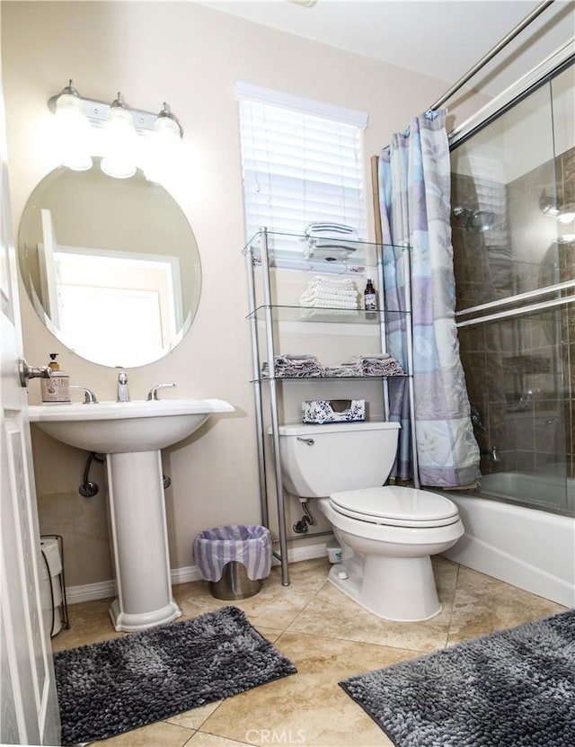 bathroom featuring tile patterned flooring, shower / bath combination with curtain, and toilet