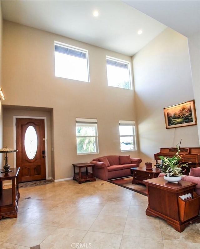 tiled living room with a wealth of natural light and a high ceiling