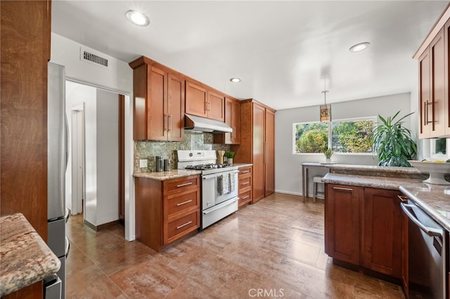 kitchen featuring pendant lighting, stainless steel appliances, light stone countertops, and tasteful backsplash