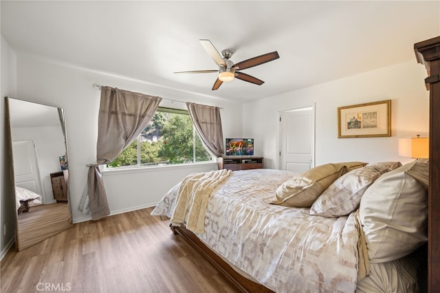 bedroom with ceiling fan and dark hardwood / wood-style floors