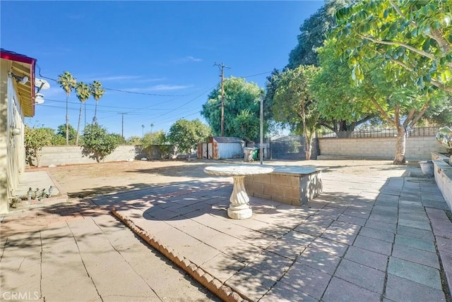 view of patio / terrace featuring a storage unit