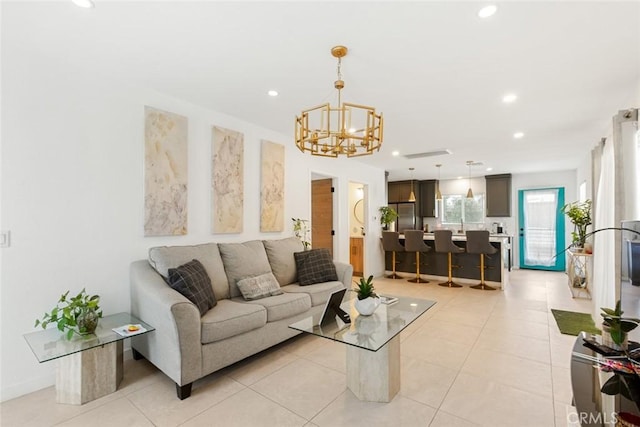 tiled living room featuring a chandelier