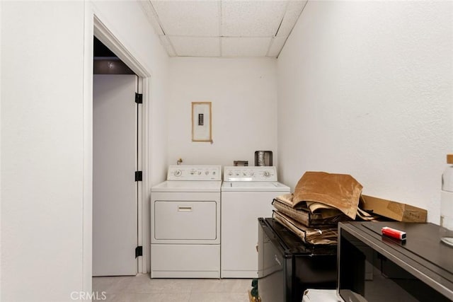 laundry room with washer and clothes dryer and light tile patterned floors