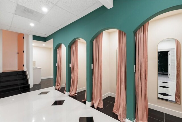 bathroom with tile patterned floors and a drop ceiling