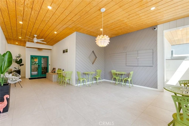 rec room featuring ceiling fan, wooden walls, and wooden ceiling