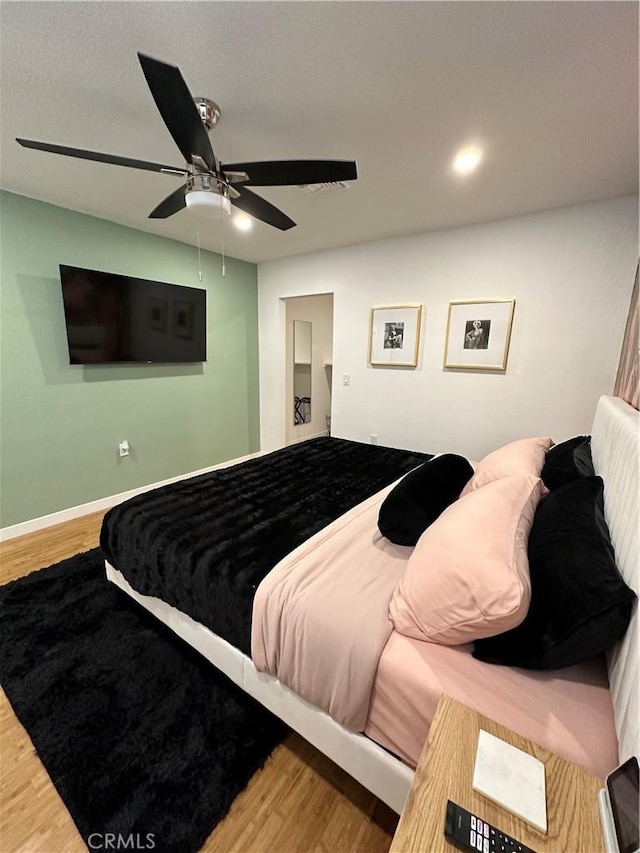 bedroom with ceiling fan and wood-type flooring