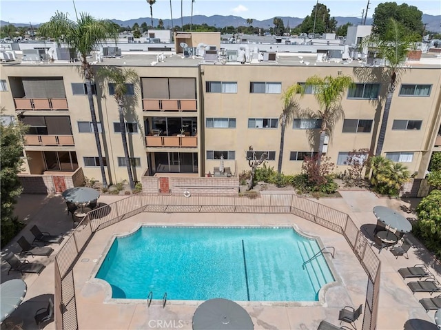 view of swimming pool with a mountain view