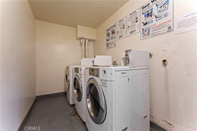 clothes washing area with washing machine and dryer