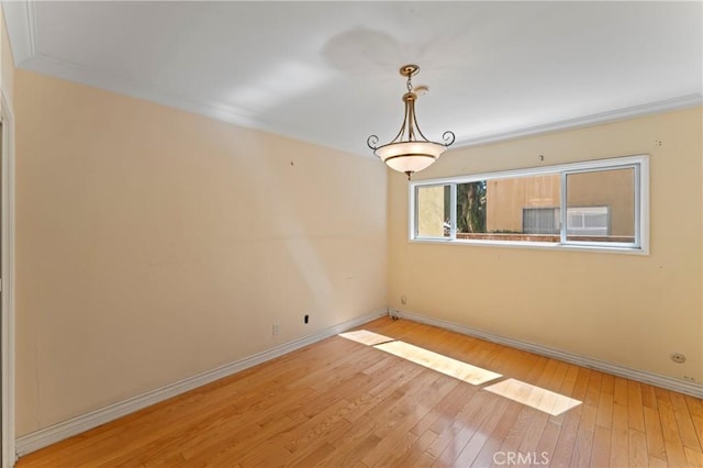 unfurnished room with light wood-type flooring and ornamental molding