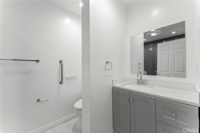 bathroom featuring toilet and vanity