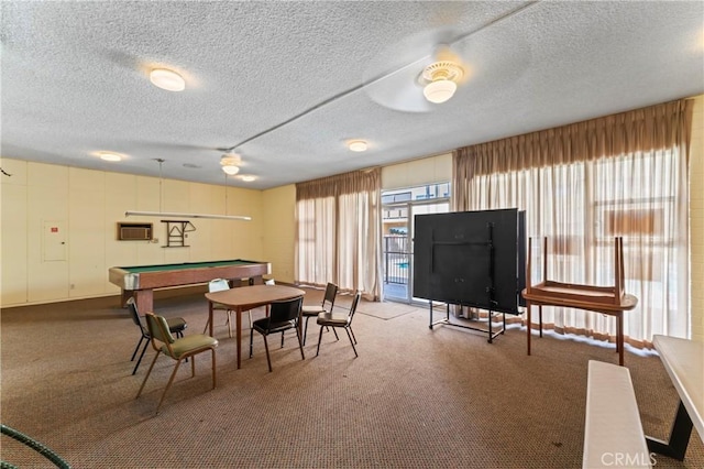 rec room with a textured ceiling, billiards, and carpet