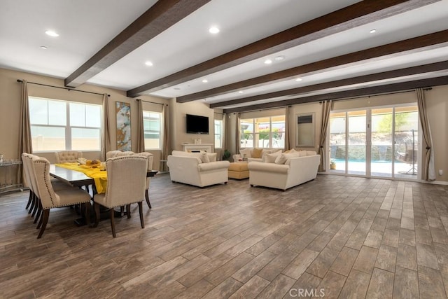 interior space with beamed ceiling and dark hardwood / wood-style floors