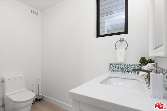 bathroom featuring vanity and toilet