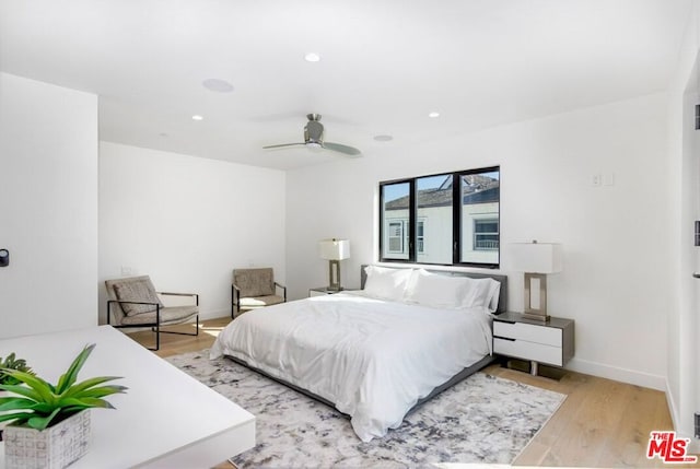 bedroom featuring ceiling fan and light hardwood / wood-style flooring