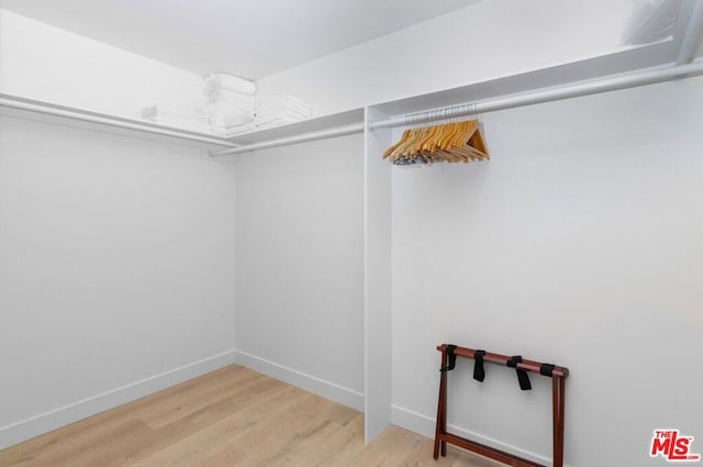 walk in closet featuring hardwood / wood-style floors