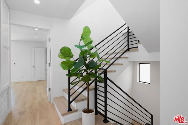 stairs featuring hardwood / wood-style flooring