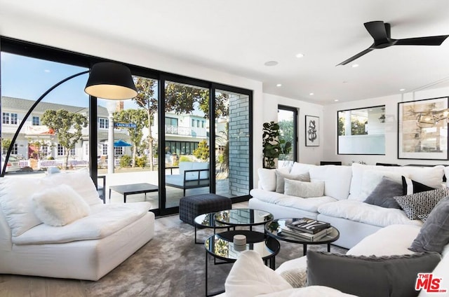 living room featuring wood-type flooring and ceiling fan