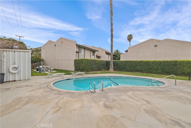 view of swimming pool featuring a patio area