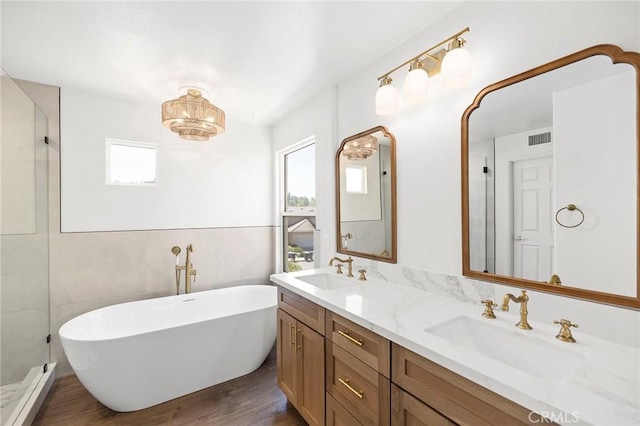 bathroom with separate shower and tub, hardwood / wood-style floors, and vanity