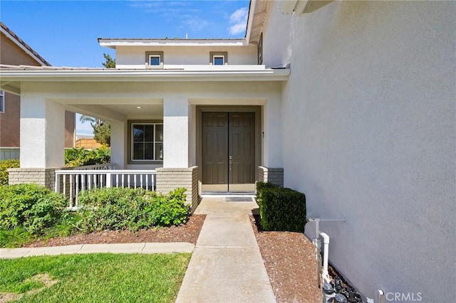 property entrance with covered porch