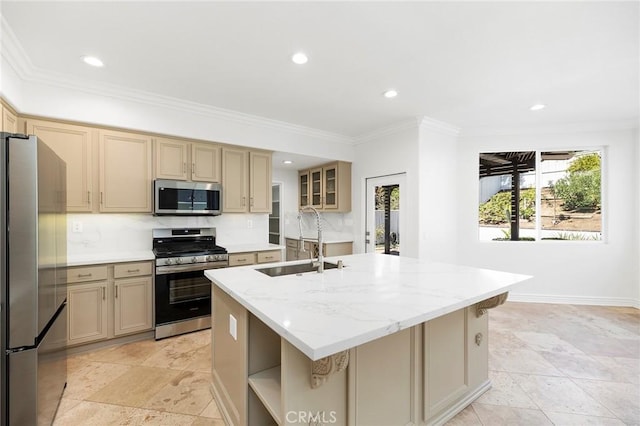 kitchen featuring sink, stainless steel appliances, light stone counters, crown molding, and a kitchen island with sink