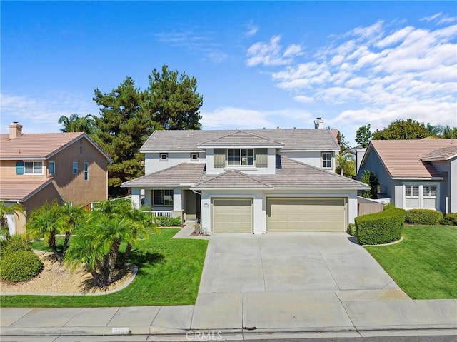 view of front facade featuring a garage and a front lawn