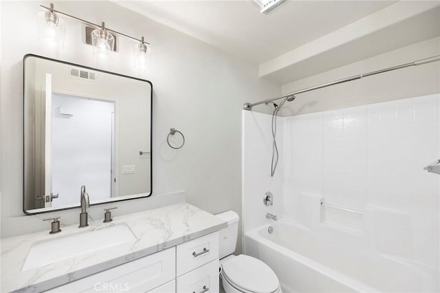 full bathroom featuring washtub / shower combination, vanity, and toilet