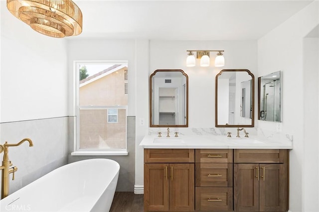 bathroom with a bath, vanity, and hardwood / wood-style flooring