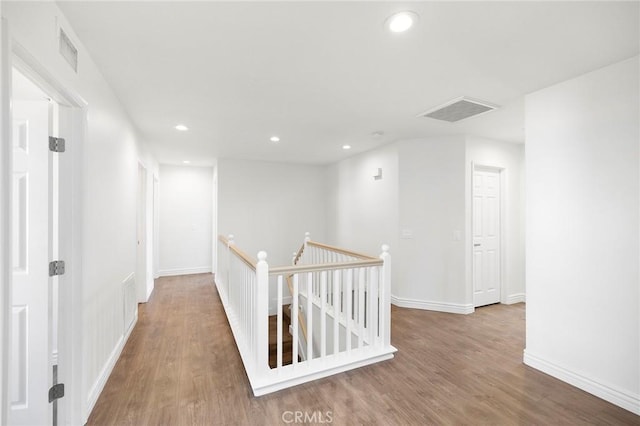 corridor with hardwood / wood-style flooring