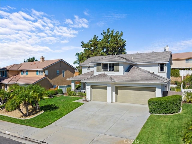 view of front of home with a garage and a front lawn