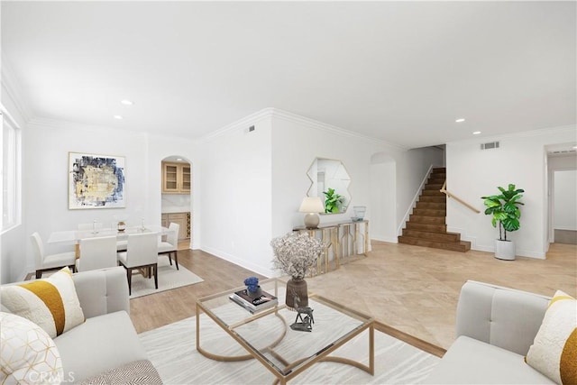 living room featuring light hardwood / wood-style flooring and ornamental molding