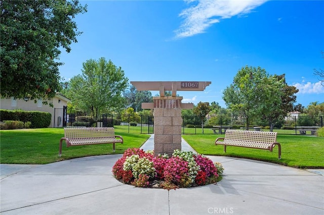 view of property's community with a lawn