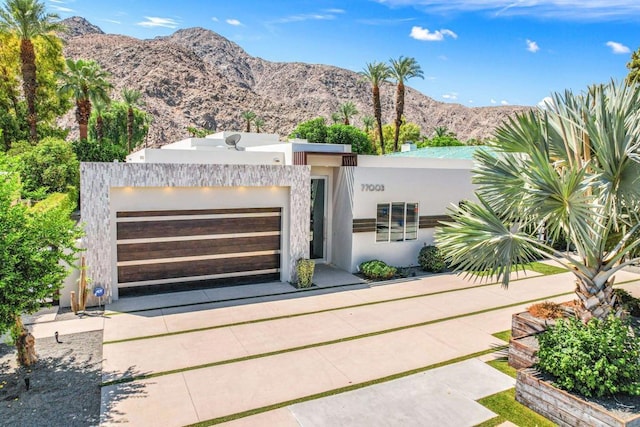 view of front of property with a mountain view and a garage