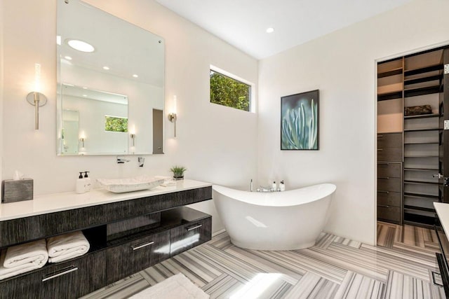 bathroom with vanity and a bath