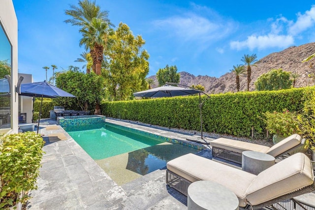 view of swimming pool featuring a mountain view and a patio area