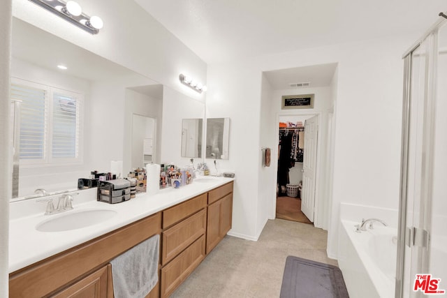 bathroom with vanity and a bathtub