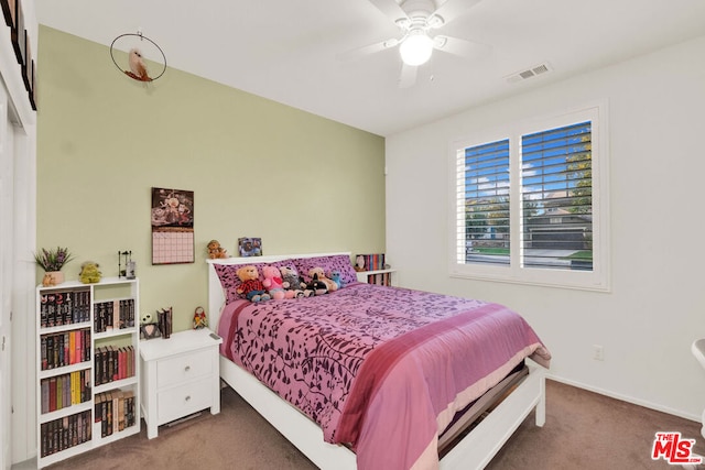 bedroom with ceiling fan and dark colored carpet