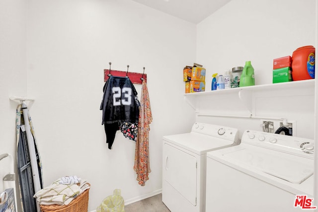 clothes washing area featuring washer and clothes dryer