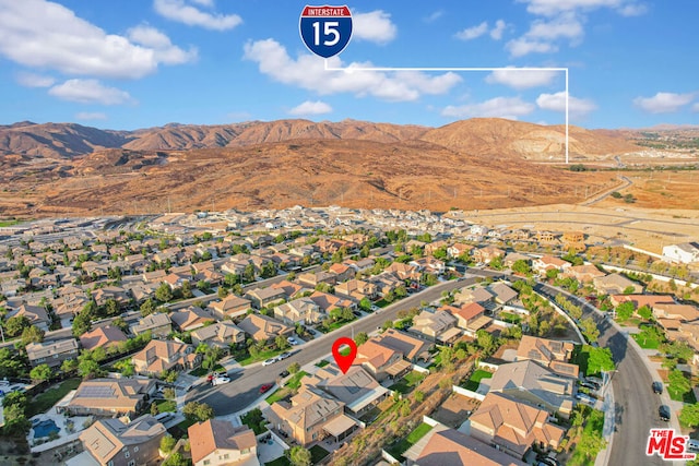 birds eye view of property featuring a mountain view