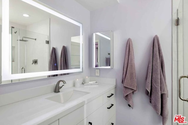 bathroom with walk in shower and vanity