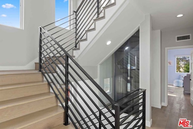 stairs featuring wood-type flooring