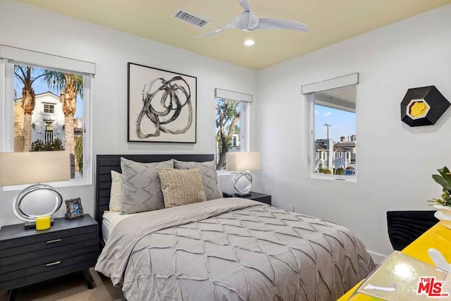 bedroom with ceiling fan and hardwood / wood-style flooring