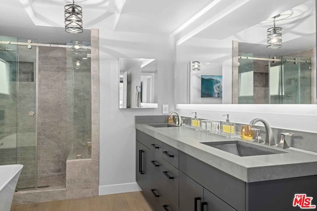 bathroom featuring vanity, shower with separate bathtub, and hardwood / wood-style floors