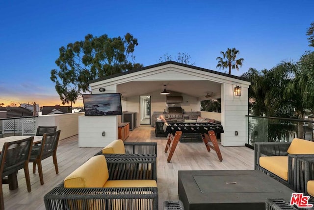 wooden deck with ceiling fan, grilling area, and an outdoor living space