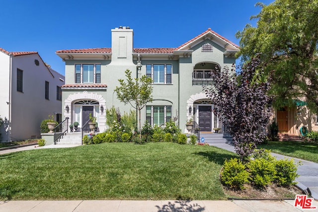 mediterranean / spanish-style house featuring a front yard