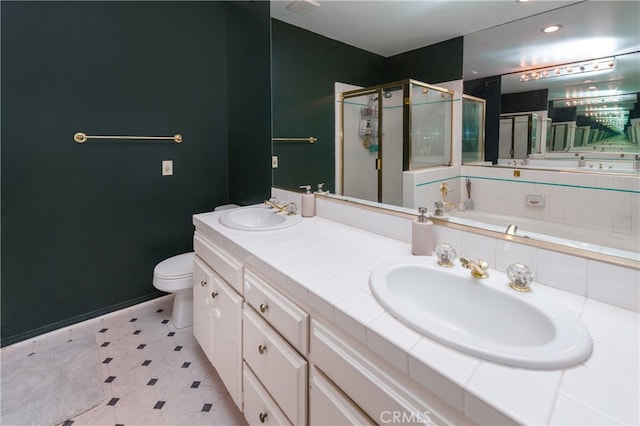 bathroom featuring vanity, toilet, and a shower with door