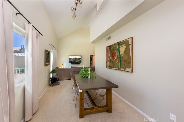 corridor featuring light carpet and vaulted ceiling