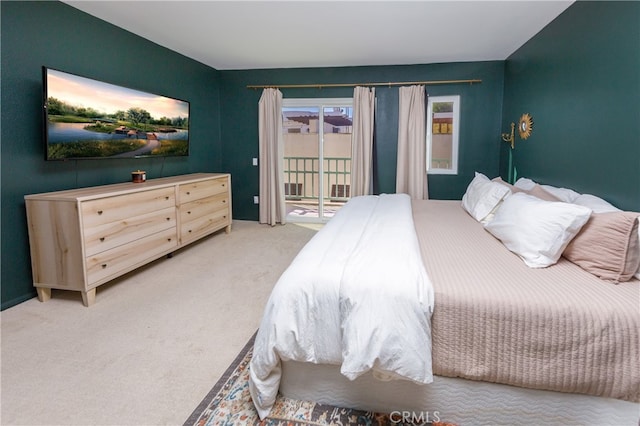 carpeted bedroom with access to exterior