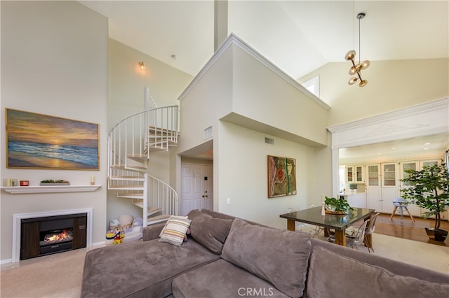 carpeted living room with high vaulted ceiling