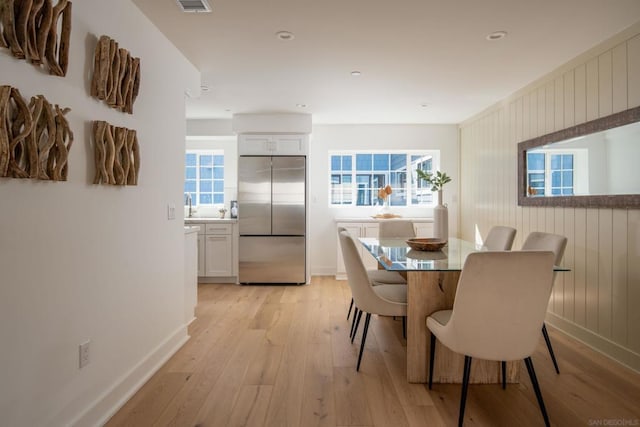 dining room featuring sink and light wood-type flooring